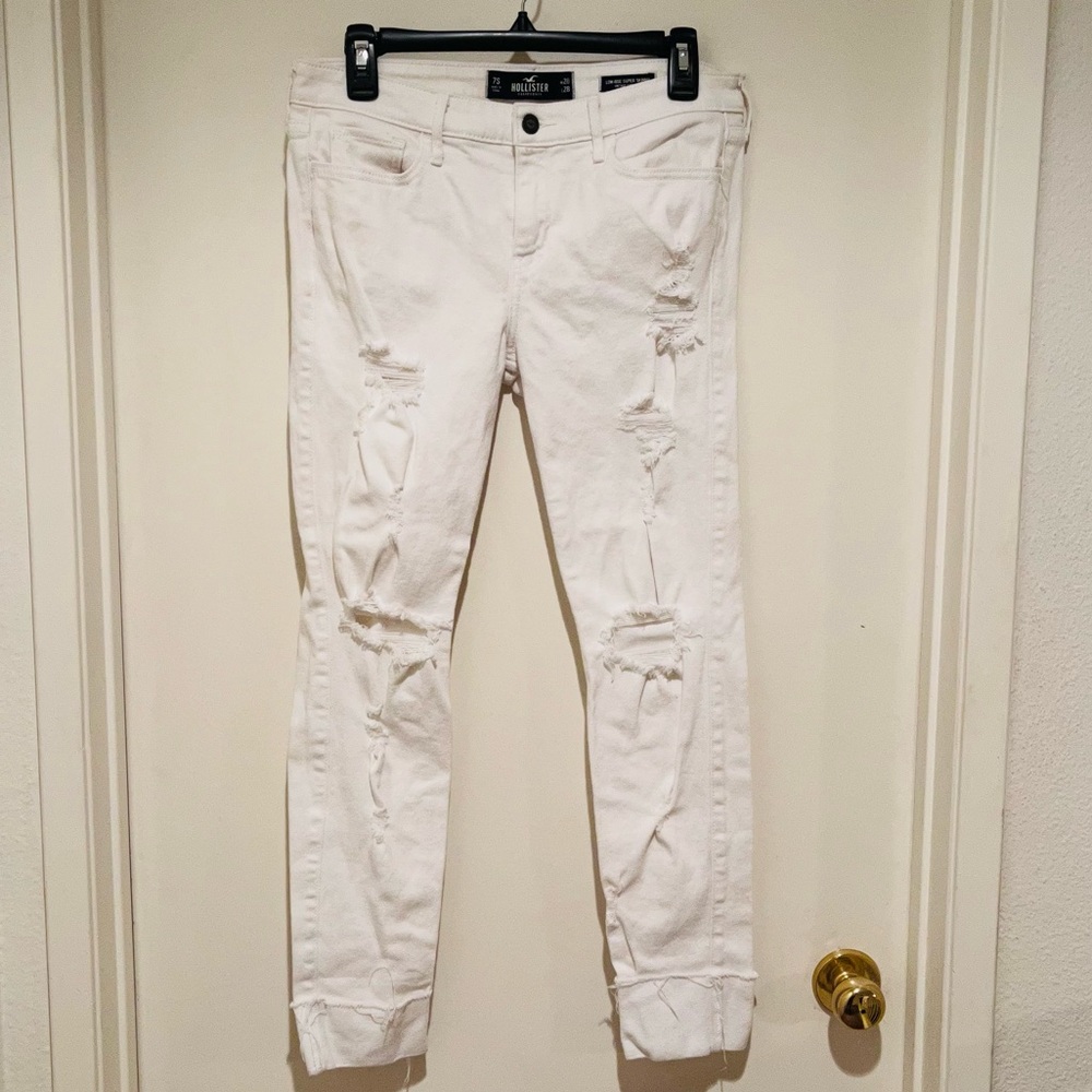 Hollister white ripped jeans with cuffed legs.